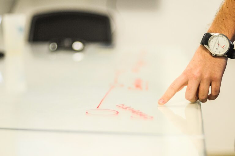 propertystream employee pointing to a diagram on a white piece of paper which is a plan for a new website