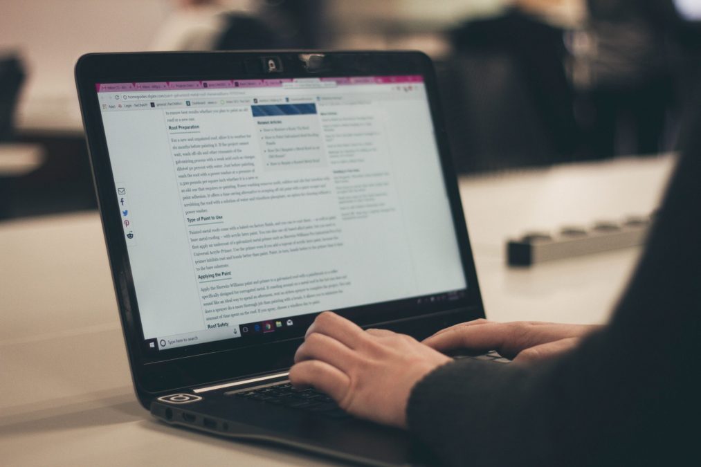 propertystream employee typing a blog post for a client on a laptop