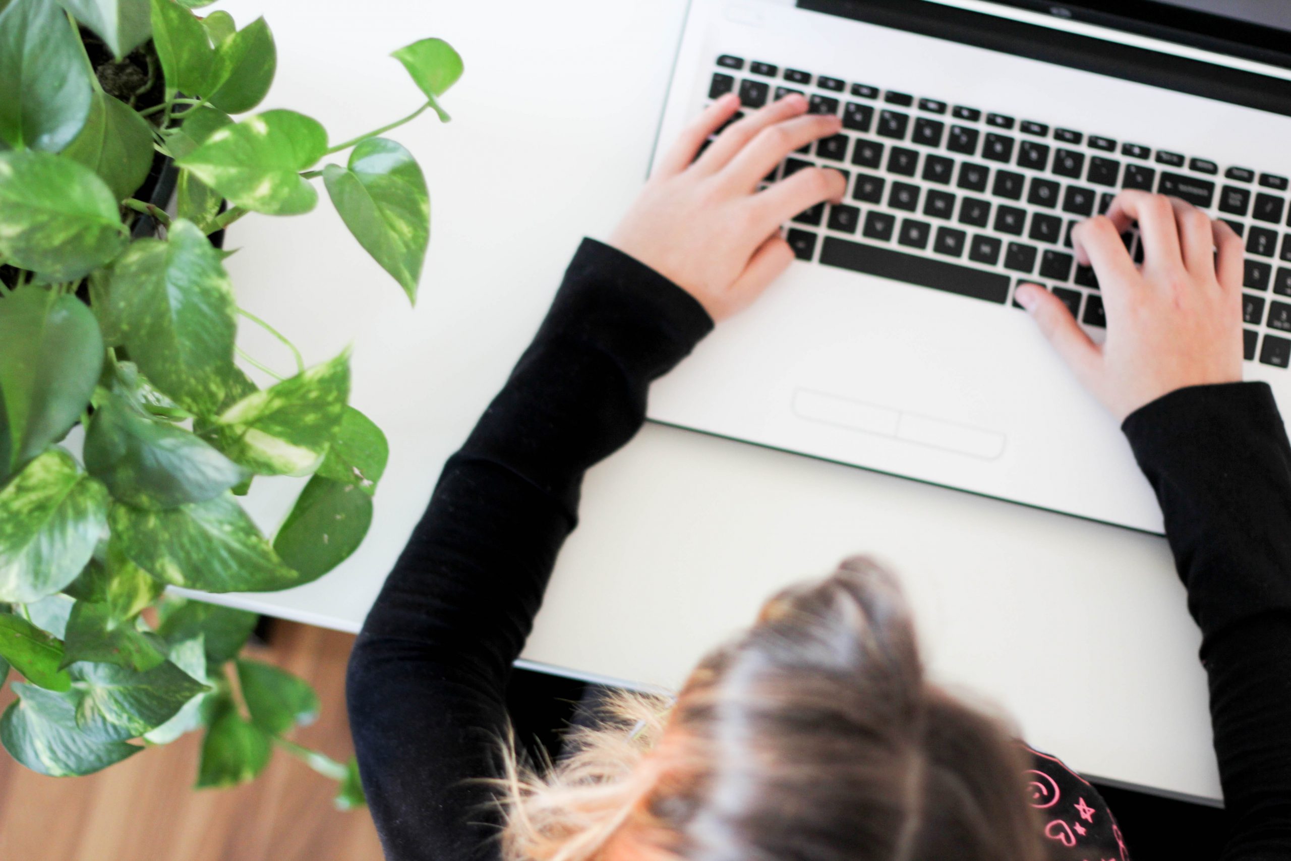 lady at her laptop typing out an email marketing campaign