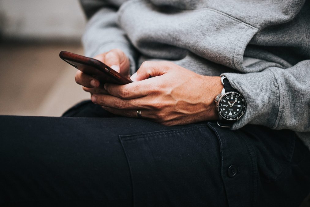 lady holding a smart phone browsing social media apps