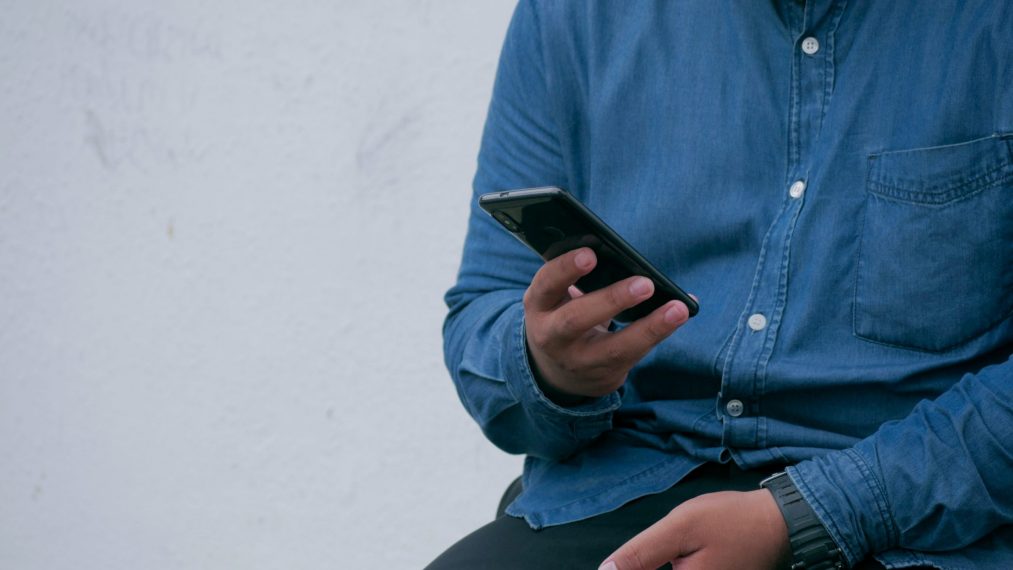 man browsing instagram on his phone