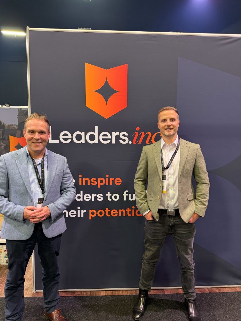 Robin and Eddy from PropertyStream by their newly created Leaders.inc logo at the EA Masters 2025